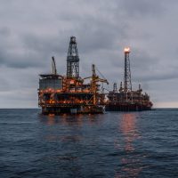 FPSO tanker vessel near Oil Rig platform. Offshore oil and gas industry